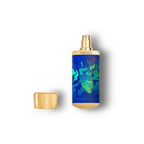 Perfume bottle with blue and green pattern on a white background