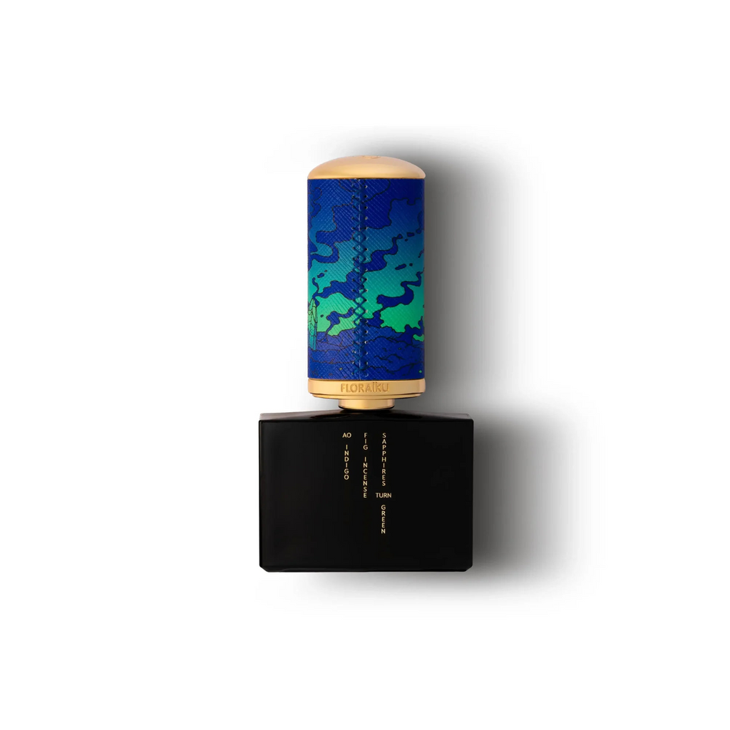 Perfume bottle with blue and green camouflage design on a white background