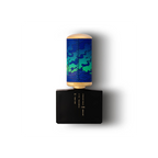 Perfume bottle with blue and green camouflage design on a white background